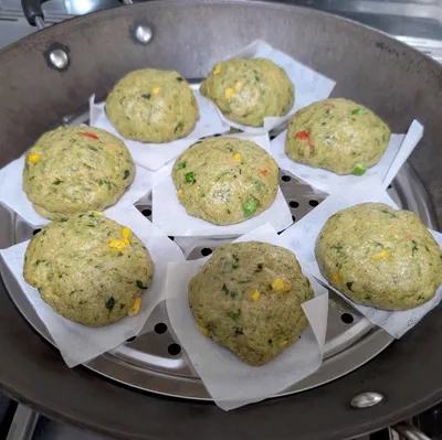 A homemade spinach bun with frozen corns and peas